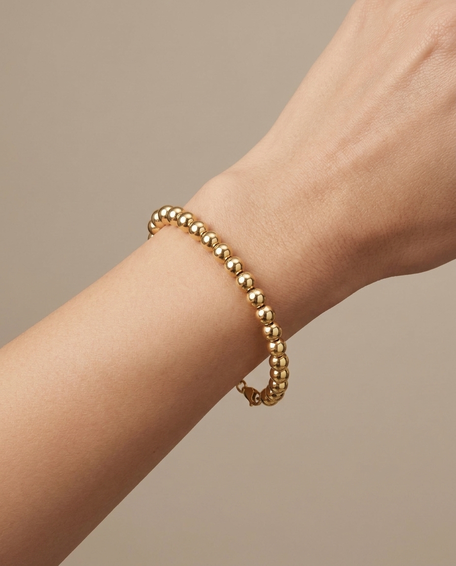 14KT Yellow Gold 7 MM Hollow Ball Bracelet 7.5" on model