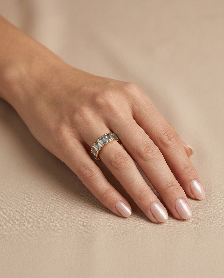 14KT Yellow Gold Emerald Cut Aquamarine Eternity Ring on model