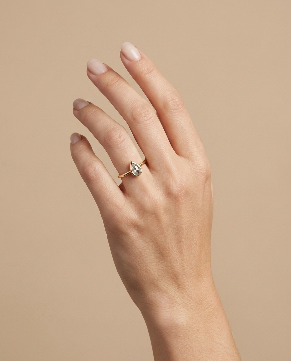 14KT Gold Ring with Single Bezeled Pear Shape Diamond on model