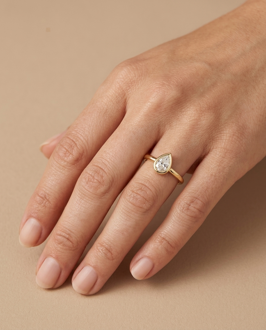 14KT Gold Ring with Single Bezeled Pear Shape Diamond on model