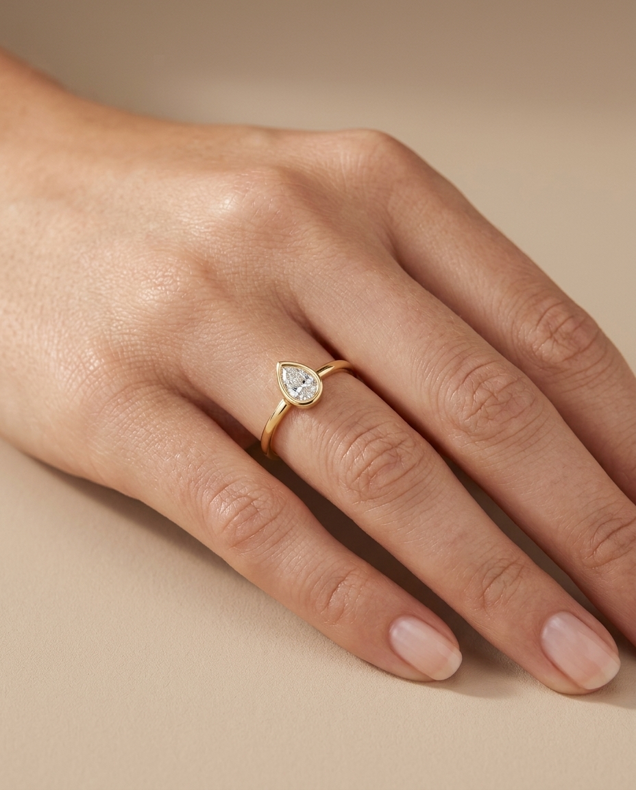 14KT Gold Ring with Single Bezeled Pear Shape Diamond on model